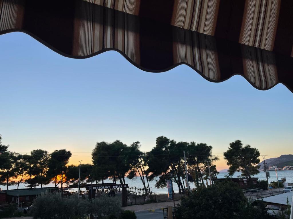 uma vista a partir de uma janela de uma praia ao pôr-do-sol em Molla Hotel Restorant em Shëngjin