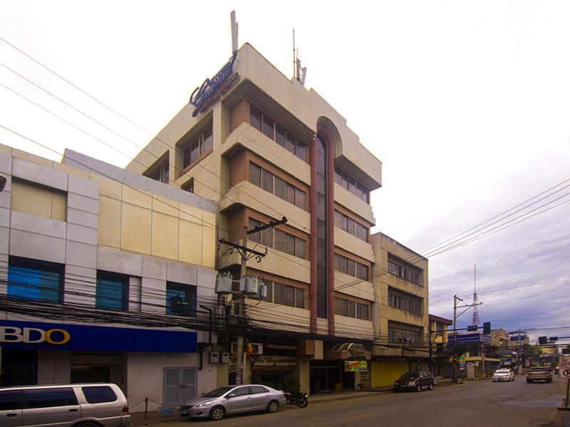 a building with cars parked in front of it at Grand City Hotel Inc. in Cagayan de Oro