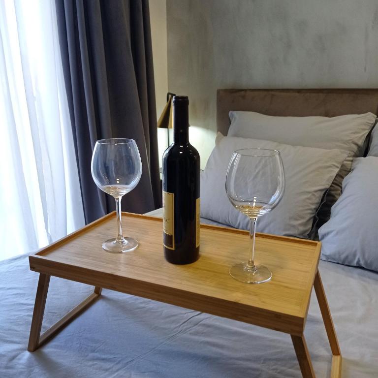 a bottle of wine and two wine glasses on a table at KaLuMa in Belgrade