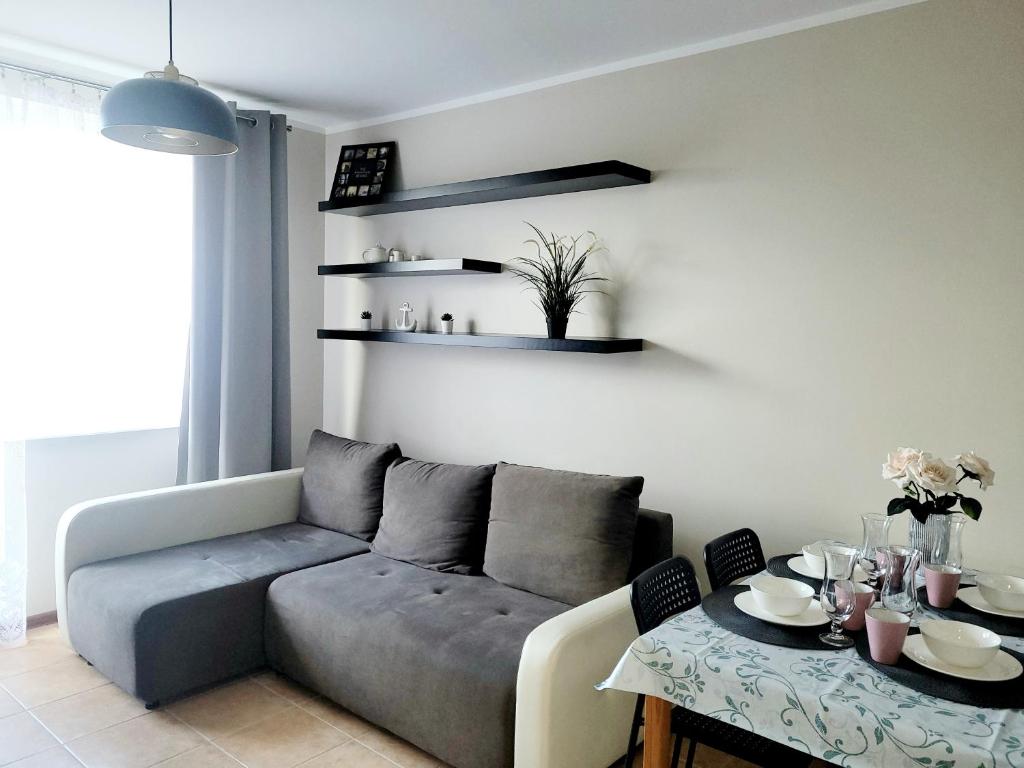a living room with a couch and a table at Apartament Prima in Reda
