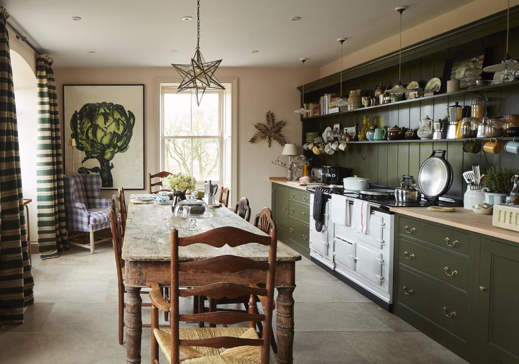 a kitchen with a table and a dining room at North Farm in Walworth