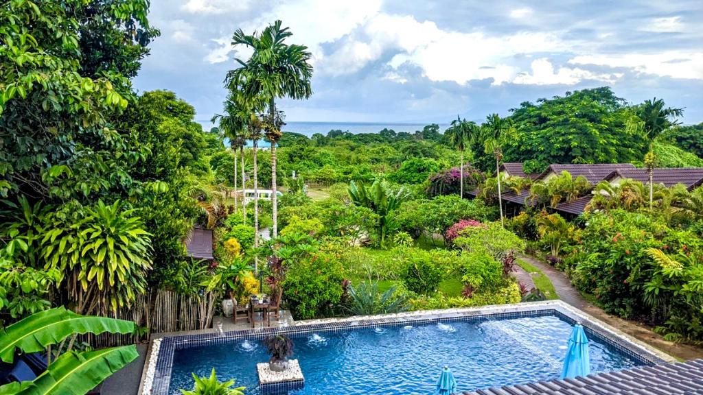 an overhead view of a swimming pool in a garden at Atmaland Resort in Kep