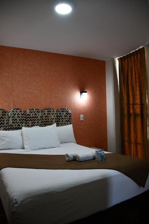 Postel nebo postele na pokoji v ubytování Hotel Flamingos
