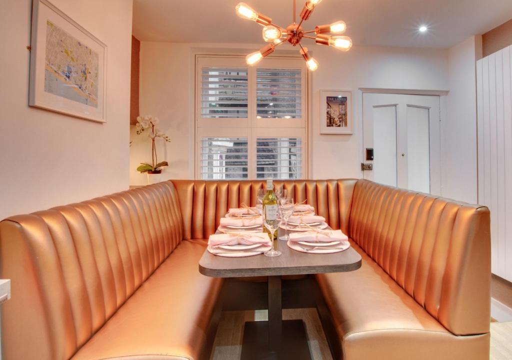 a dining room with a table with dishes on it at Corner Cottage in Brighton & Hove