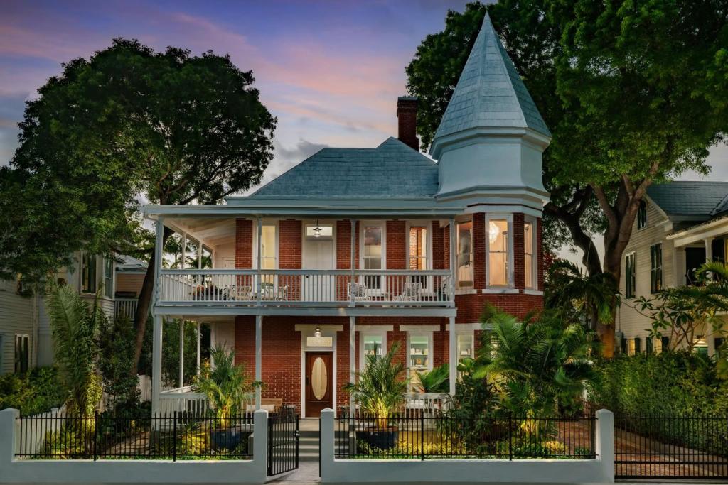 a large house with a turret at Takeover at the Grand Maloney by Brightwild in Key West