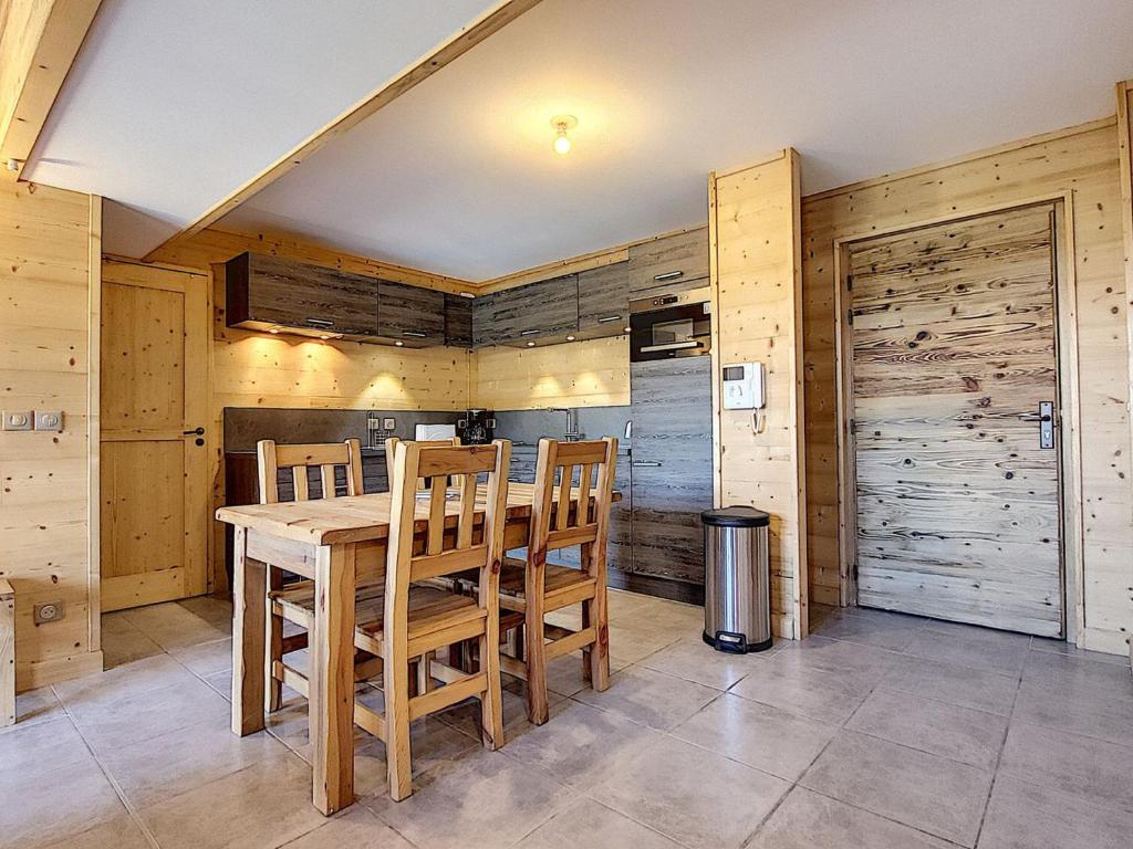 a dining room with a wooden table and chairs at Appartement La Toussuire, 4 pièces, 6 personnes - FR-1-416-68 in La Toussuire
