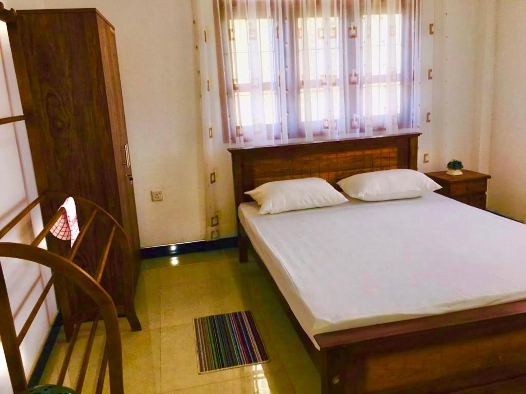 A bed or beds in a room at st anns holiday home negombo