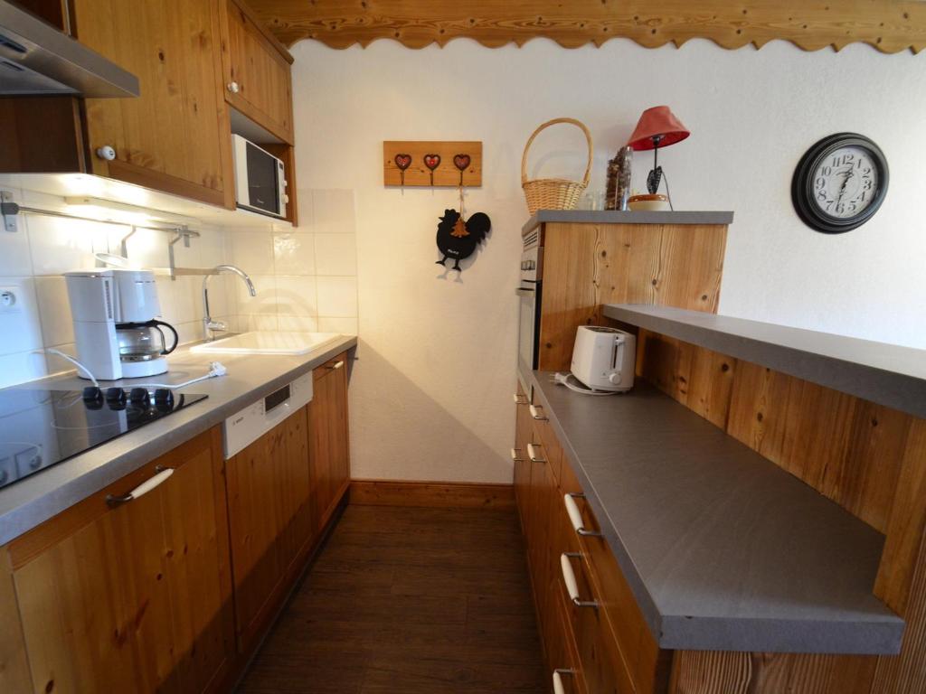 uma cozinha com armários de madeira e uma bancada em Appartement Les Menuires, 2 pièces, 4 personnes - FR-1-452-15 em Les Menuires