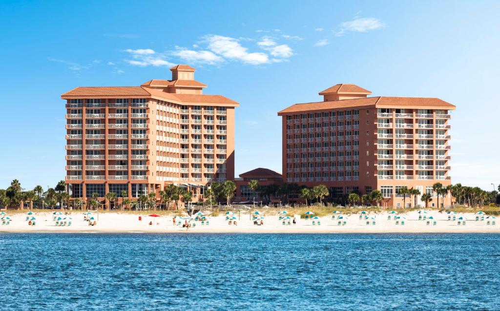 uma praia com edifícios e pessoas na praia em Perdido Beach Resort em Orange Beach