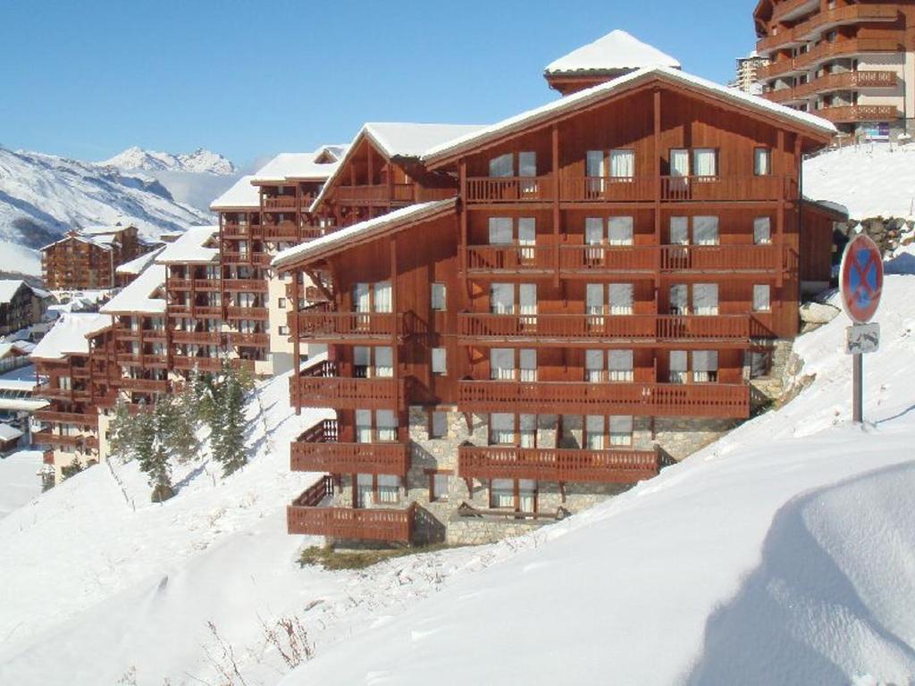 a large wooden building in the snow with snow at Appartement Les Menuires, 2 pièces, 4 personnes - FR-1-452-253 in Les Menuires