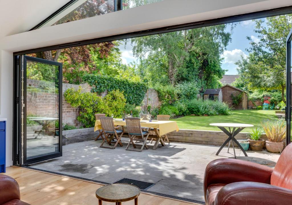 a living room with a large sliding glass door exposing a patio at Red Doors in Canterbury