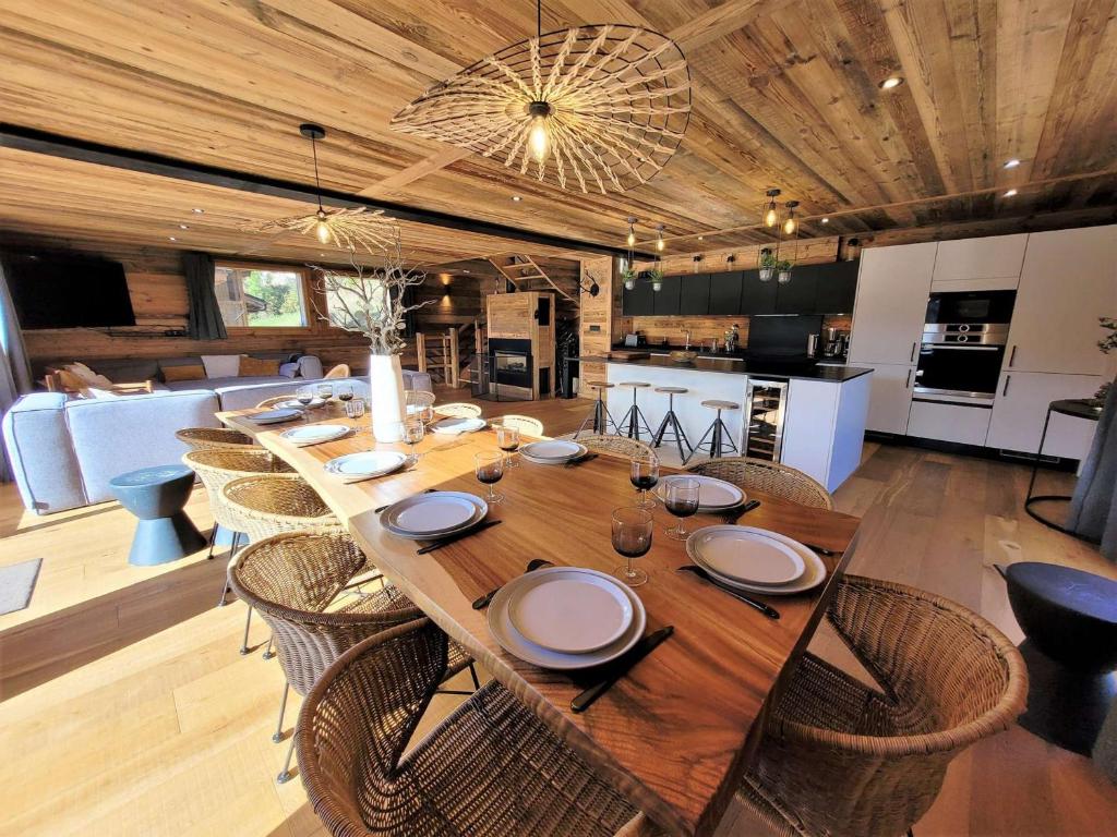 a dining room with a long wooden table and chairs at Chalet Les Gets, 5 pièces, 14 personnes - FR-1-598-41 in Les Gets