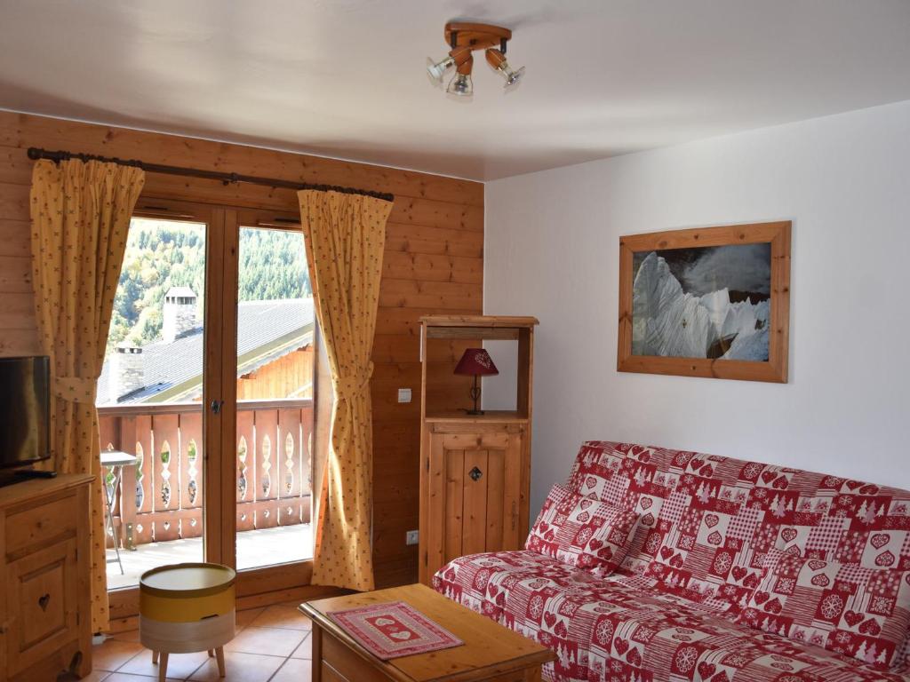 d'un salon avec un canapé et un balcon. dans l'établissement Charmant appart 3 pièces avec parking, près des pistes - FR-1-464-15, à Pralognan-la-Vanoise