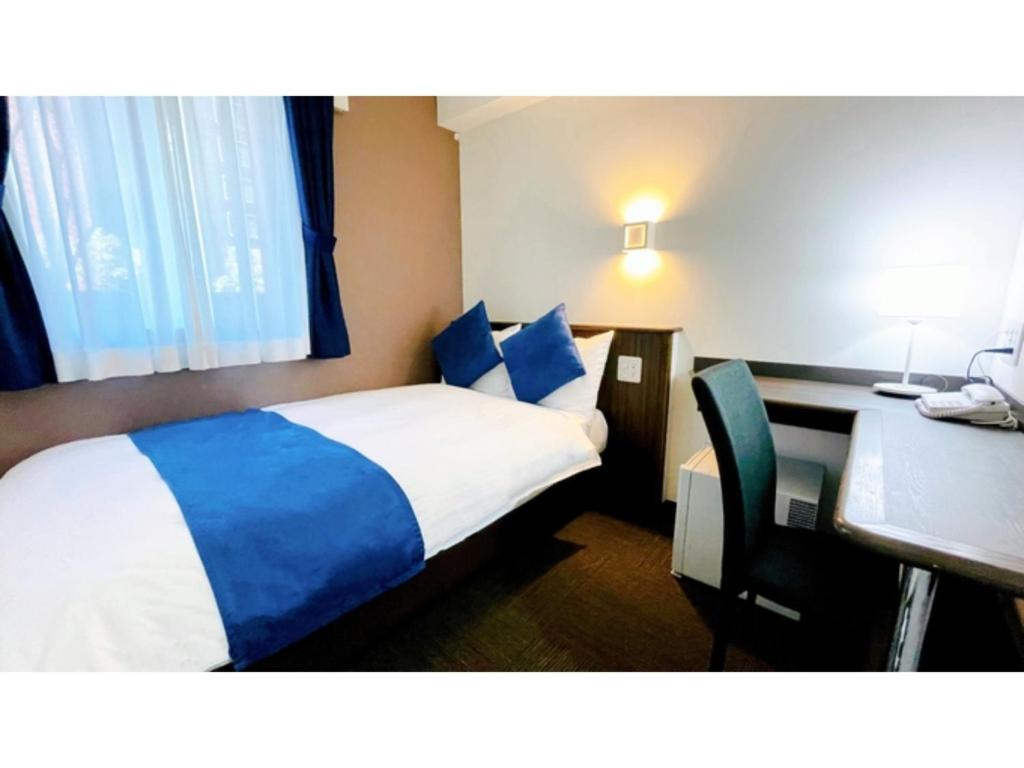 大阪Eins,Inn Umeda Higashi - Vacation STAY 29915v的带床和书桌的酒店房间