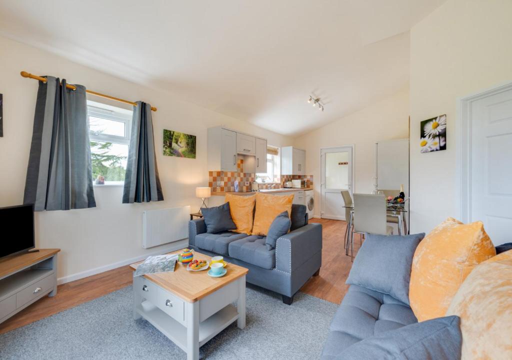 a living room with a couch and a table at The Paddocks in Horstead