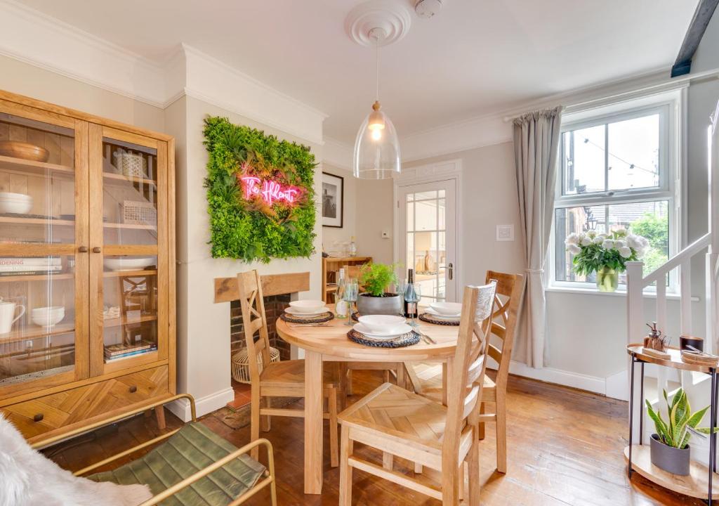 a dining room with a wooden table and chairs at The Hideout in Beccles