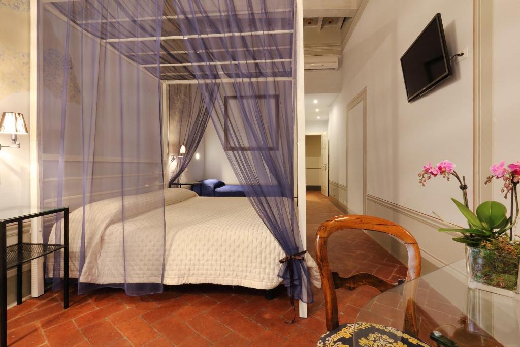 a bedroom with a canopy bed in a room at Uffizi Harmony in Florence