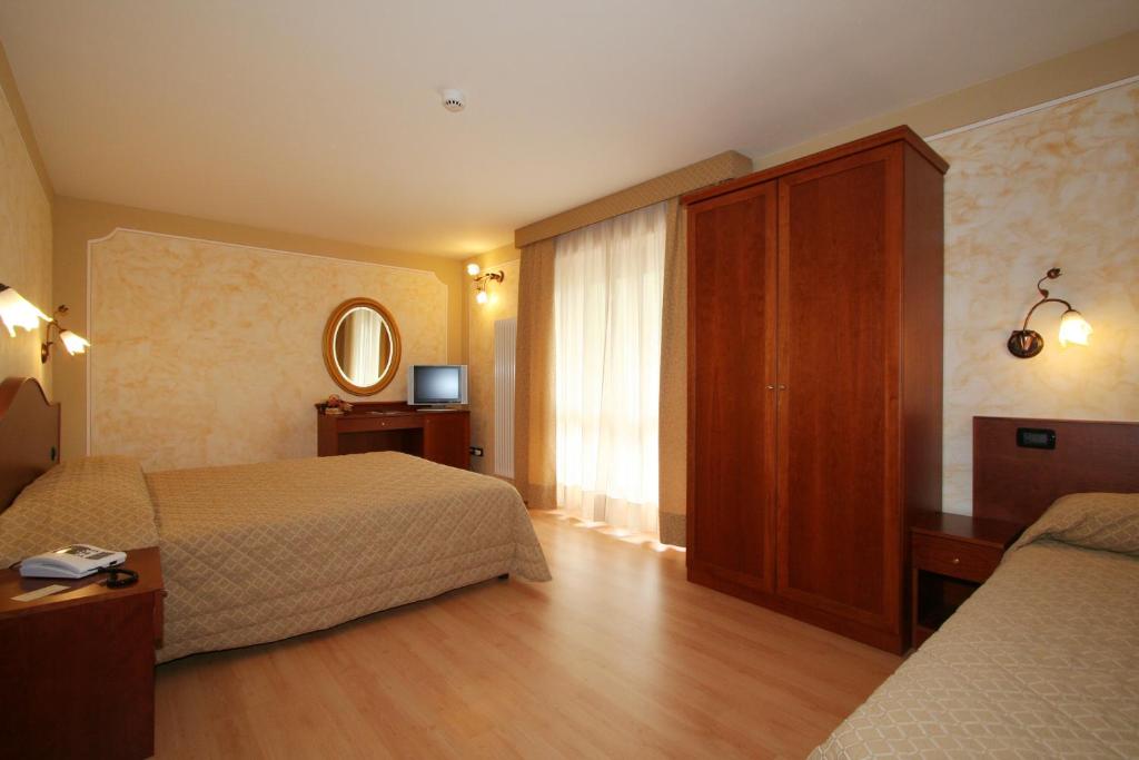 Postel nebo postele na pokoji v ubytování Hotel Dama Bianca