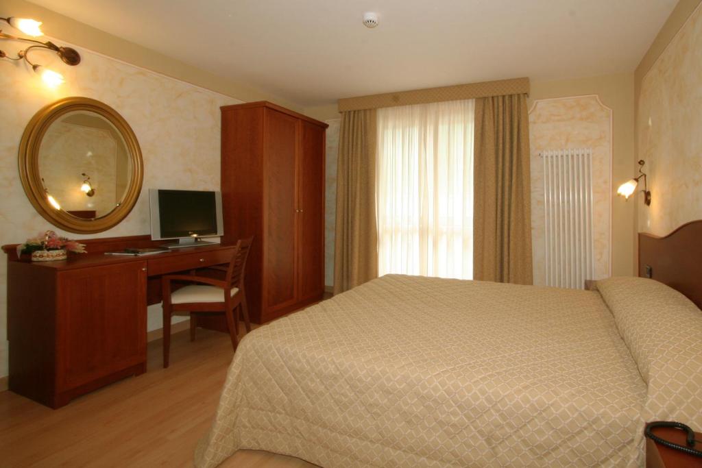 Postel nebo postele na pokoji v ubytování Hotel Dama Bianca