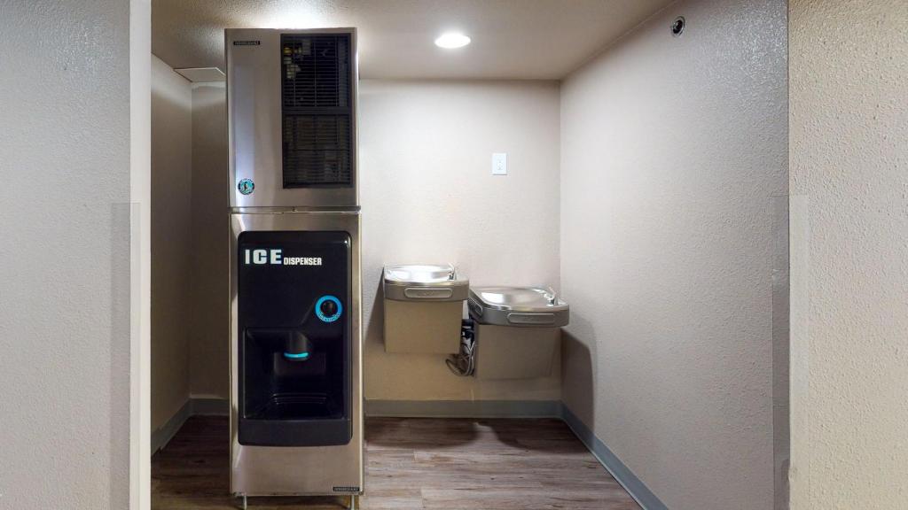 a vending machine in a room with two trash at voco College Station Aggieland by IHG in College Station