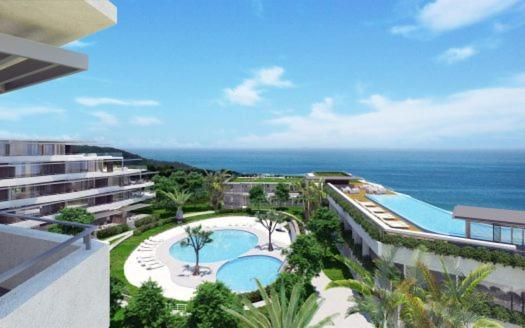 a view of a resort with a swimming pool and the ocean at Sugar Shores - Studio Apartment in Sibaya
