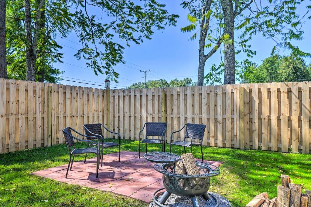 a patio with chairs and a table and a fence at Explore New River Gorge: Quiet Couple’s Retreat in Hico