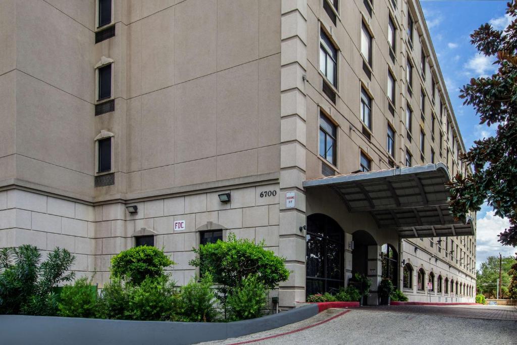 a large building with a street in front of it at SureStay Plus Hotel by Best Western Houston Medical Center in Houston