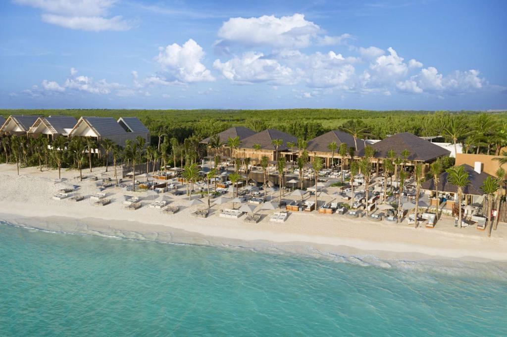 an aerial view of a beach with chairs and umbrellas at Banyan Tree Mayakoba in Playa del Carmen