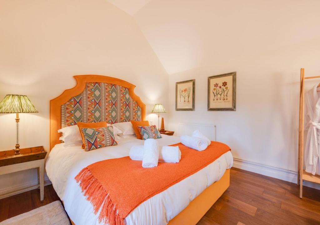 a bedroom with a large bed with towels on it at The Potting Shed 