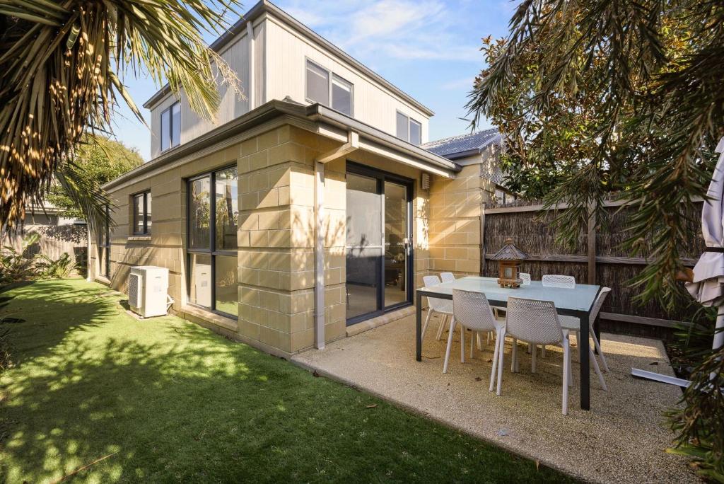 a house with a table and chairs in the yard at Beaches on Church in Cowes