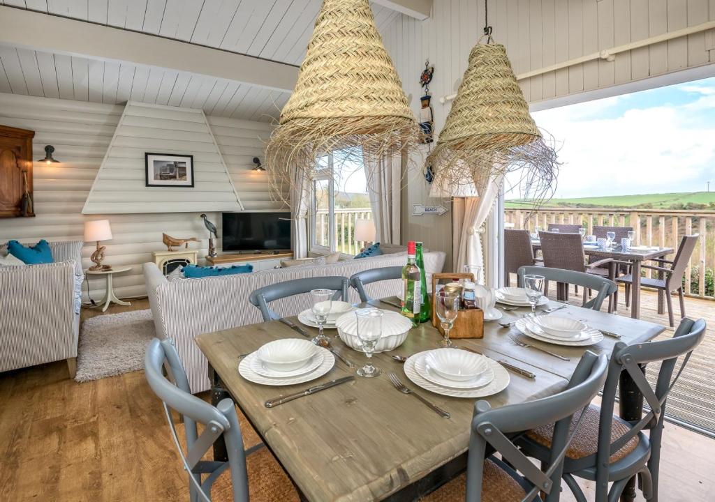 a dining room with a wooden table and chairs at 9 Braich Farm in Llanengan