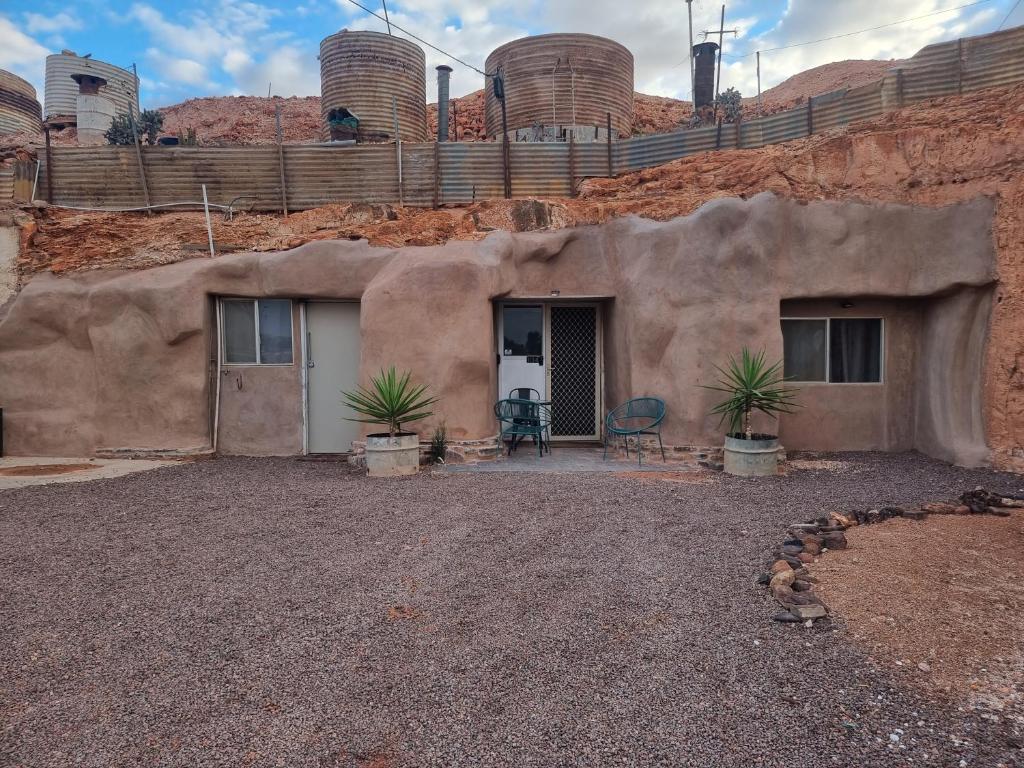 una casa nel deserto con due piante di 894 Holly Court a Coober Pedy