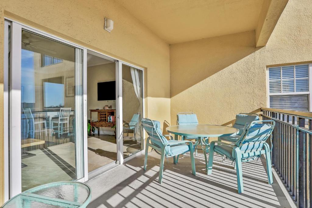 a patio with a table and chairs on a balcony at Palms of Treasure Island 208 in St. Pete Beach