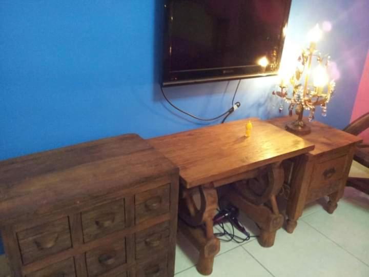 a wooden desk with a television on a wall at Hualien Seaside B&amp;B in Hualien City