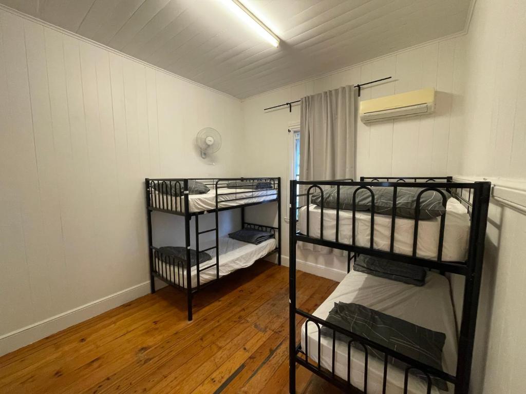 a room with three bunk beds in it at Gonow Family Backpackers Hostel in Brisbane