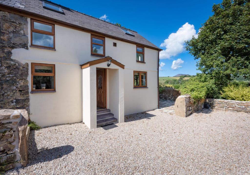 a detached house with a driveway in front of it at Caeau Bach in Bottwnog