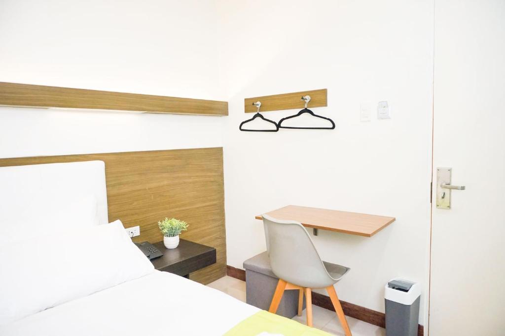 Postel nebo postele na pokoji v ubytování Benrose Hotel