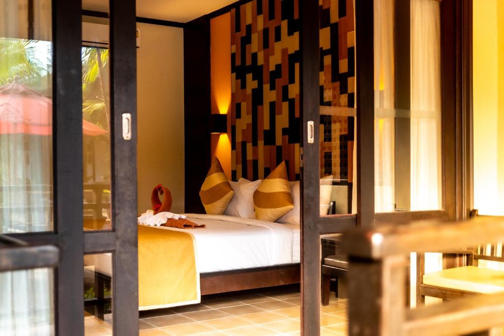 Postel nebo postele na pokoji v ubytování Am Samui Palace