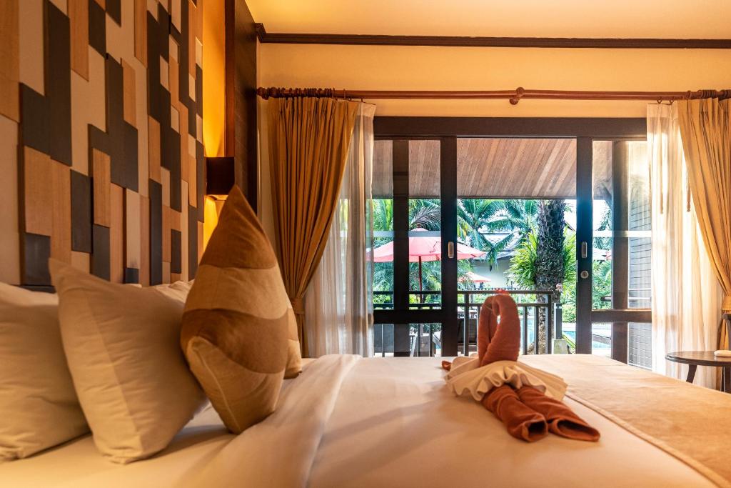 Postel nebo postele na pokoji v ubytování Am Samui Palace