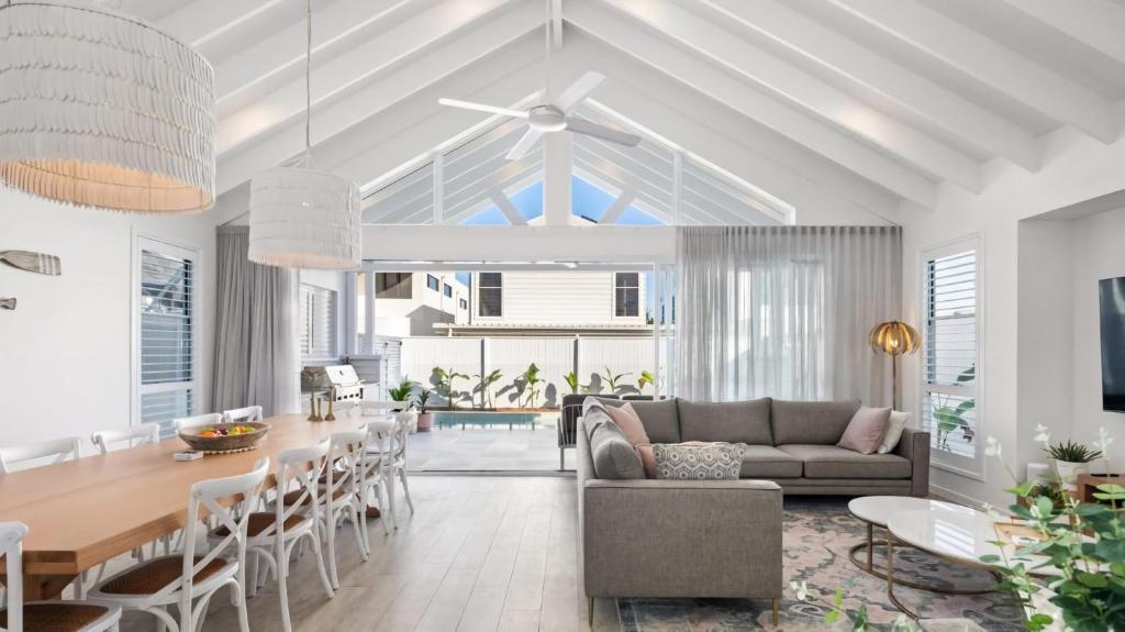 a living room with a couch and a table at Gone Coastal in Kingscliff