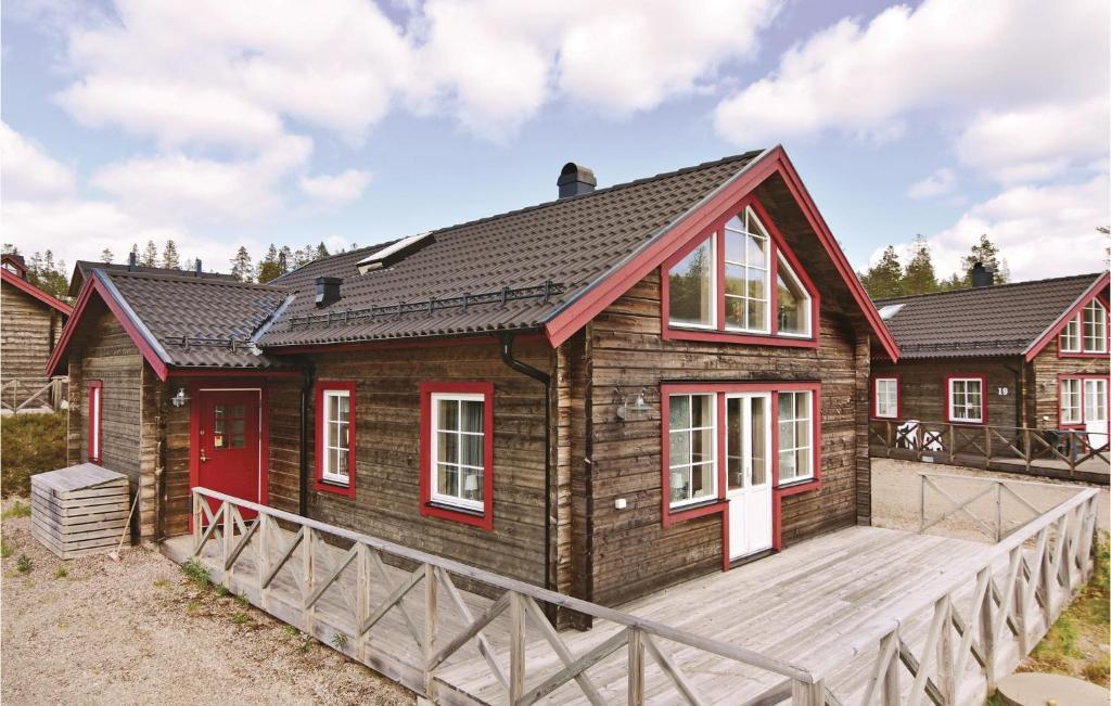a house with a red door and a wooden deck at Awesome Home In Slen With 3 Bedrooms, Sauna And Wifi in Sälen