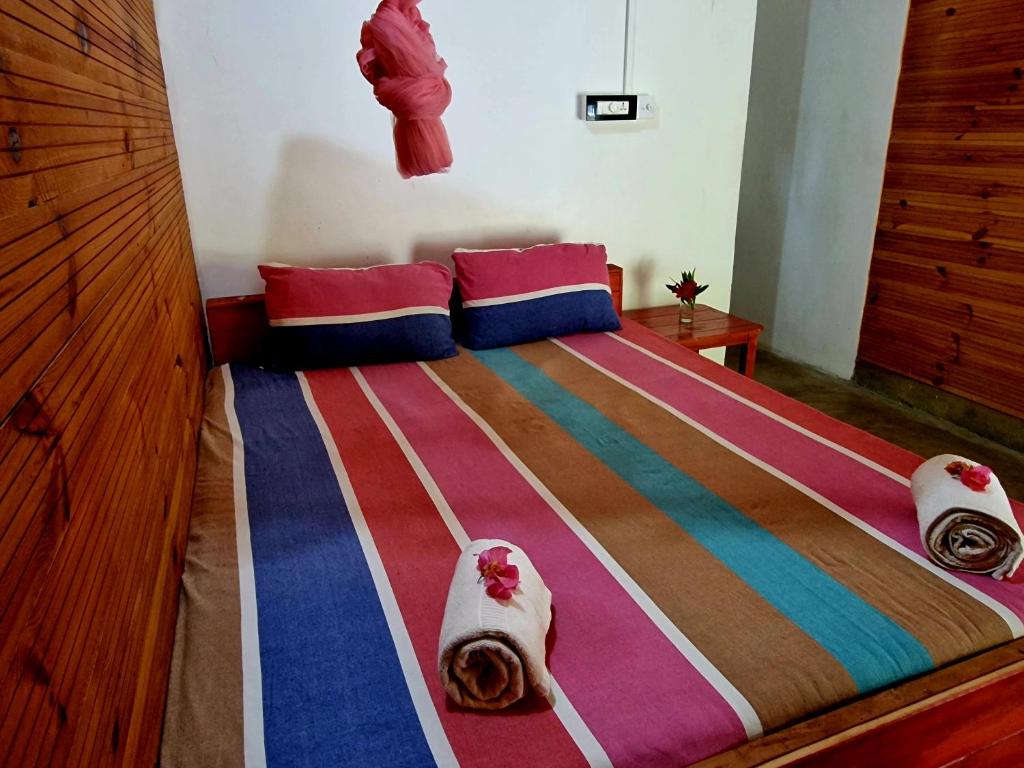 a bedroom with a bed with towels on it at Walkers hostel in Trincomalee