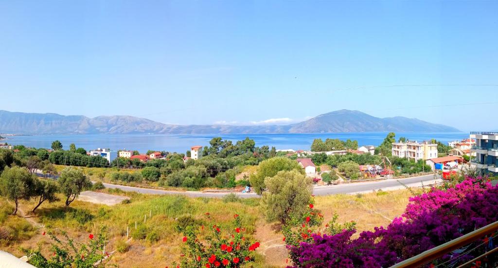 a view of a town with flowers on a hill at Hotel Sirena in Vlorë