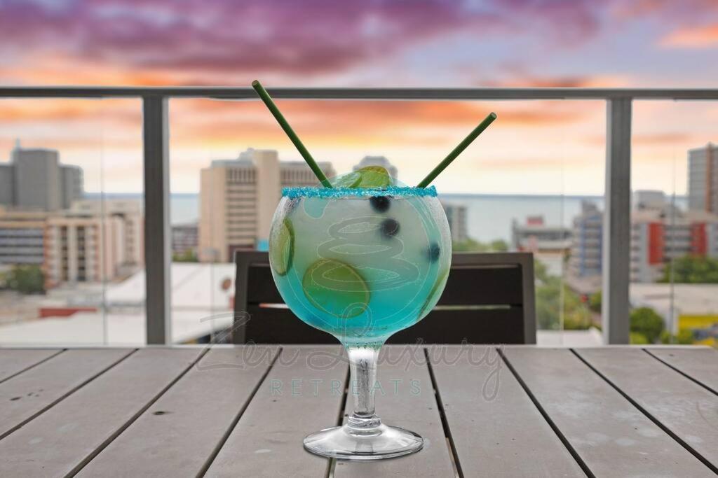 a drink sitting on a table with a view of a city at ZEN OCEAN BLISS - Cozy 2-BR/2-BA Sea View Retreat in Darwin