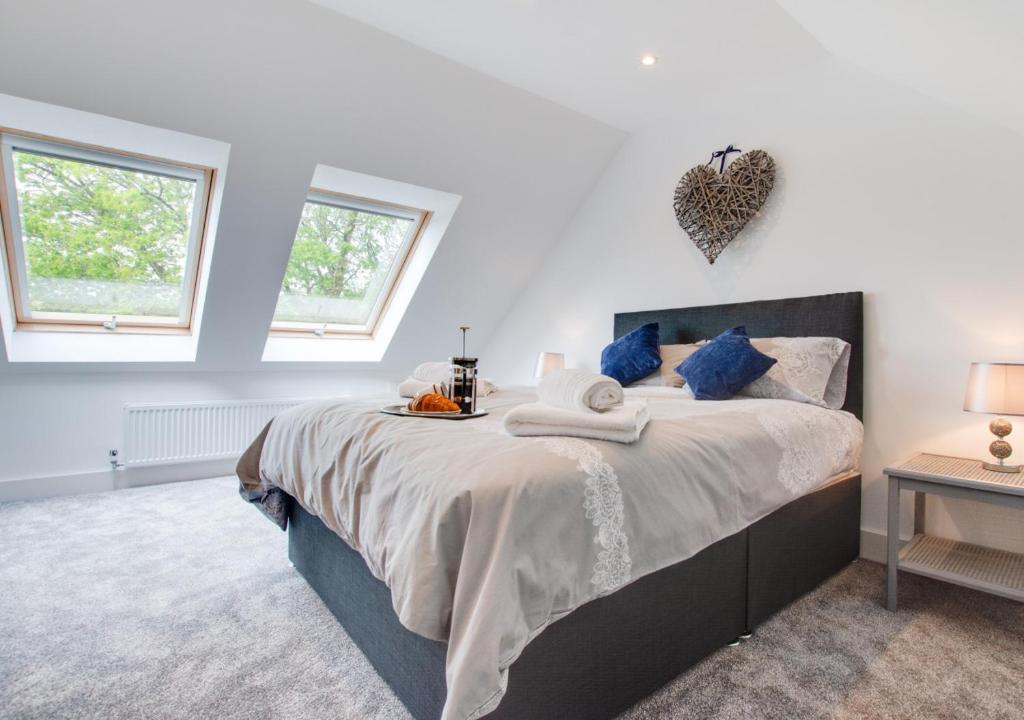 a bedroom with a large bed with blue pillows at Tyisaf in Llanfynydd