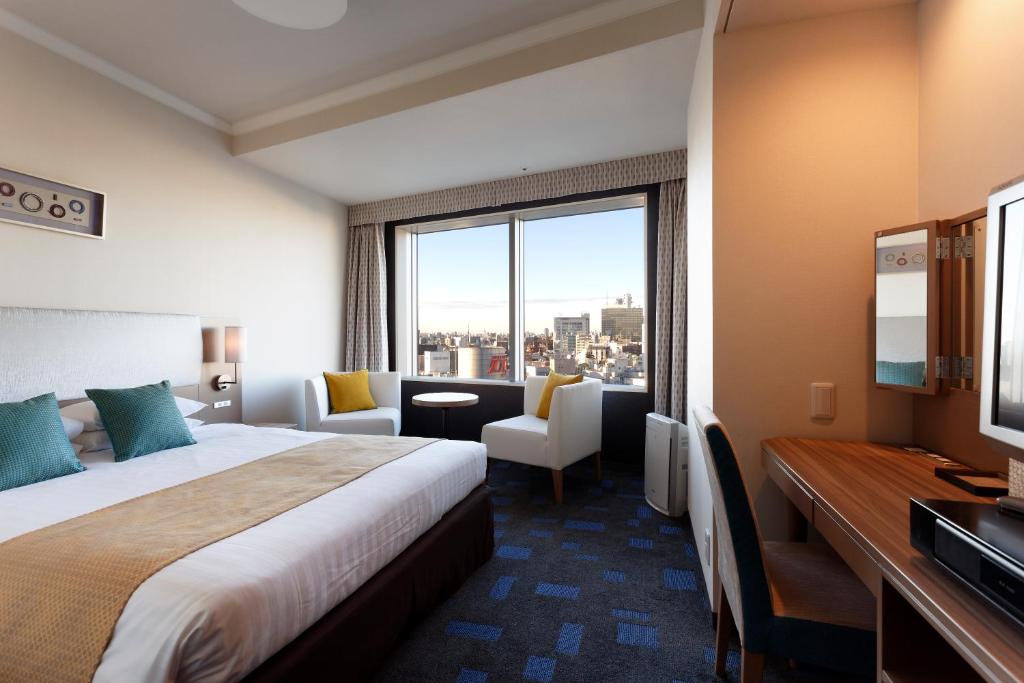 a hotel room with a bed and a large window at Shibuya Excel Hotel Tokyu in Tokyo