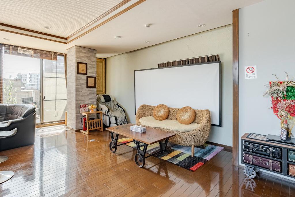 a living room with a couch and a table at Residence Ferie Nara station in Nara