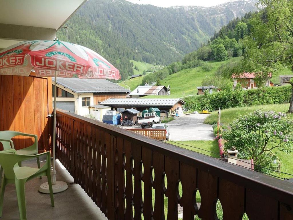 a balcony with a table and an umbrella at Appartement Arêches-Beaufort, 2 pièces, 4 personnes - FR-1-342-200 in Arêches-Beaufort