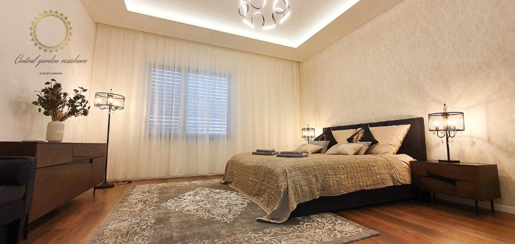 a bedroom with a large bed and a window at Central garden residence in Levice