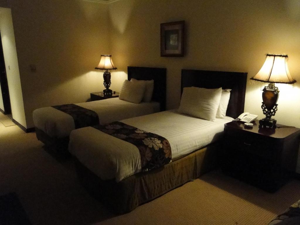 En eller flere senge i et værelse på Shanasheel Palace Hotel
